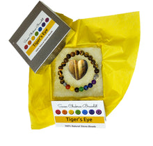 Load image into Gallery viewer, Tiger's eye heart and chakra bracelet in jewelry box with yellow tissue paper, information card and lid
