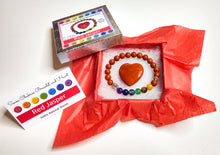 Load image into Gallery viewer, Red jasper heart and chakra bracelet in jewelry box with red tissue paper, information card and lid